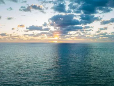 a sunset over a large body of water at Villa Lumea in Miami Beach