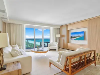 a living room with white furniture and a view of the ocean at Villa Lumea in Miami Beach