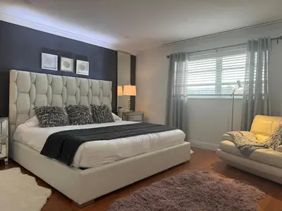 a bedroom with a large white bed and a window at The Hollywood Beach Experience in Hollywood