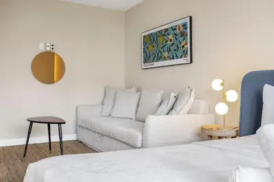 a living room with a couch and a table at Beachfront Studio with Resort Access STR-02630 in Sunny Isles Beach