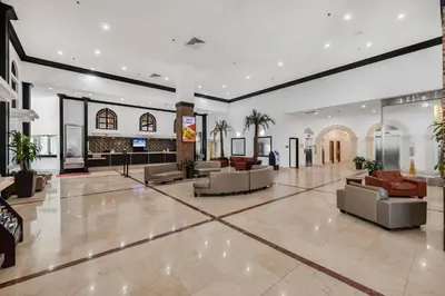 a lobby with couches and chairs in a building at Beachfront Studio with Resort Access STR-02630 in Sunny Isles Beach