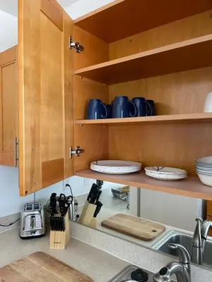 a kitchen with wooden cabinets and a sink at Beach Escape in Fort Lauderdale