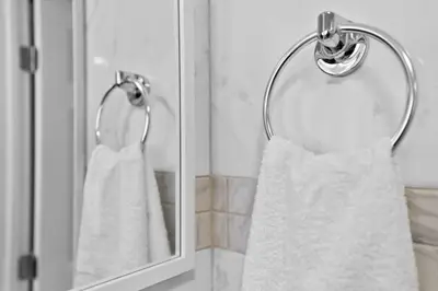 a white dress is hanging in front of a mirror at Modern 2-Bedroom Apartment in Miami