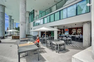 a child sitting at a table in a restaurant at Miami Lux Studio w. Kitchen City and Bay Views in Miami
