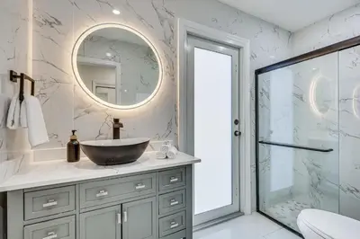 a bathroom with a sink and a mirror at 3 Mi to Hard Rock Stadium Home with Fenced-In Yard! in Miramar