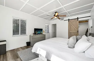 a white bedroom with a bed and a ceiling fan at The Perfect South Florida Experience in Fort Lauderdale