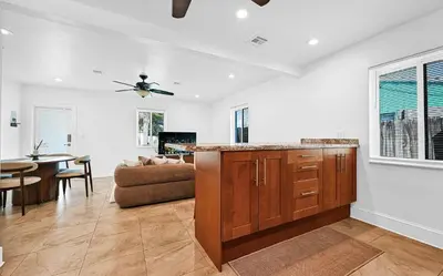 a kitchen and living room with a couch and a table at The Perfect South Florida Experience in Fort Lauderdale