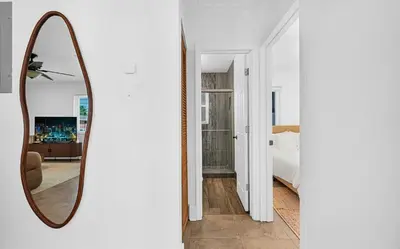 a mirror on a wall next to a bedroom at The Perfect South Florida Experience in Fort Lauderdale