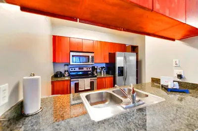 a kitchen with a sink and a stove top oven at Bright & Modern Condo in Brickell w Pool Access in Miami