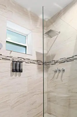 a bathroom with a shower with a glass door at Stylish 2BR/2BA Miami Home near Wynwood in Miami