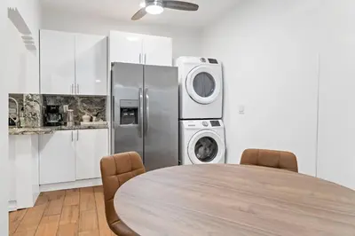 a kitchen with a table and a refrigerator at Stylish 2BR/2BA Miami Home near Wynwood in Miami