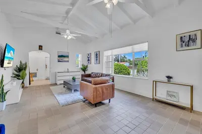 a living room with a couch and a chair at Stunning Tropical Getaway Steps To The Beach with Pool in Hollywood
