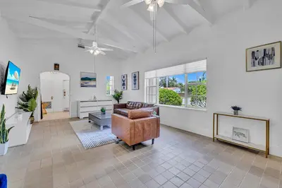 a living room with a couch and a chair at Stunning Tropical Getaway Steps To The Beach with Pool in Hollywood