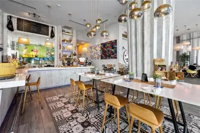 a restaurant with a bar with chairs and a counter at Corner Penthouse Ocean and City View in Hollywood
