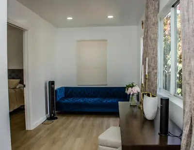 a living room with a blue couch and a table at Comfy and Relaxed in Cutler Bay