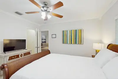 a bedroom with a bed and a ceiling fan at The Front House in Fort Lauderdale