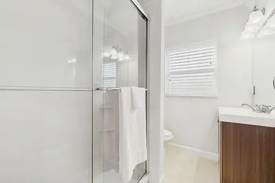 a bathroom with a shower and a toilet and a sink at The Front House in Fort Lauderdale