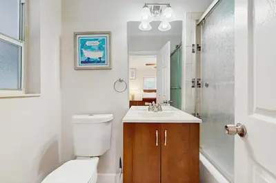 a bathroom with a toilet and a sink and a shower at The Front House in Fort Lauderdale