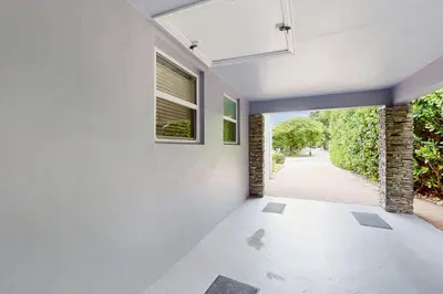 an empty room with a window and a hallway at The Front House in Fort Lauderdale