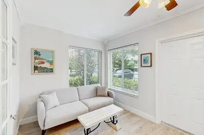 a living room with a couch and a window at The Front House & Cottage in Fort Lauderdale
