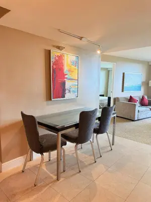 a dining room with a table and four chairs at Sunrise on the Intracoastal in Fort Lauderdale