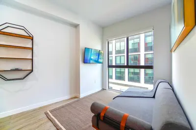 a living room with a couch and a window at Wynwood Retreat - Rooftop Pool & Neighborhood Views in Miami