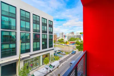 a view of a building with a red wall at Wynwood Retreat - Rooftop Pool & Neighborhood Views in Miami