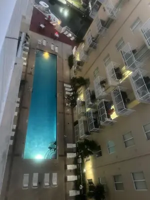 an overhead view of a building with a swimming pool at 1 Bedroom Apt With Patio in South Riverside in Miami