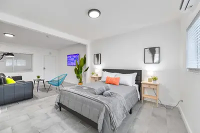 a bedroom with a bed and a living room at Modern Studio Retreat to Explore Miami in Miami