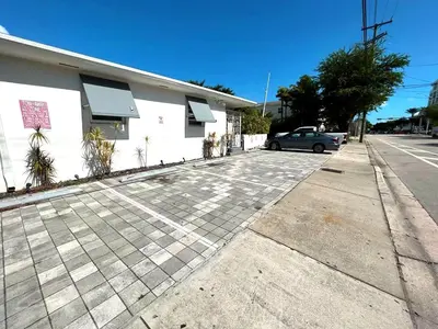 a car parked in a parking lot next to a building at Modern Studio Retreat to Explore Miami in Miami
