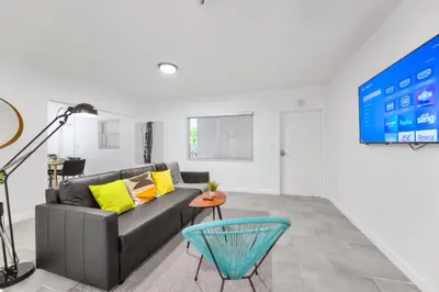 a living room with a couch and a table at Modern Studio Retreat to Explore Miami in Miami