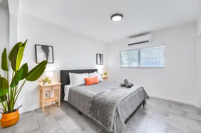 a bedroom with a bed and a potted plant at Modern Studio Retreat to Explore Miami in Miami