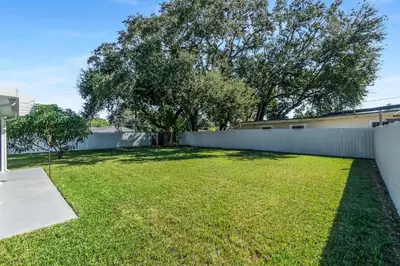 a backyard with a fence and a grass yard at RJ Home Away From Home LLC in Miami Gardens