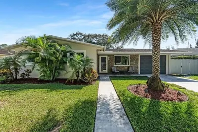 a palm tree in front of a house at RJ Home Away From Home LLC in Miami Gardens