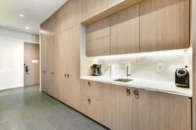 a kitchen with wooden cabinets and a sink at GREAT STUDIO - Luxe Brickell Stay Near Bay in Miami