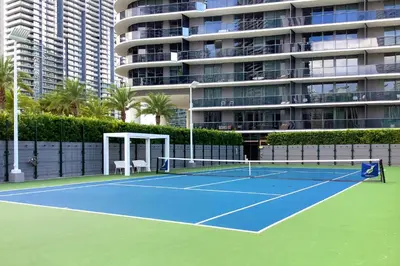 a tennis court in front of a large building at GREAT STUDIO - Luxe Brickell Stay Near Bay in Miami