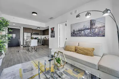 a living room with a couch and a kitchen at Waterline Corner Vies 2Br 2BA Suites in Miami