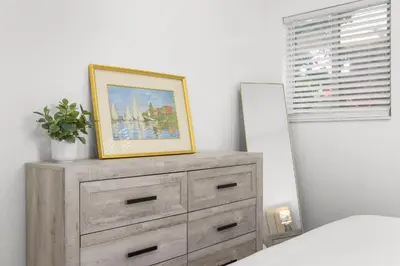 a picture on top of a dresser in a bedroom at Cozy By The Blue in Miami
