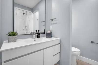 a white bathroom with a sink and a toilet at Almost Famous - Pool - Jacuzzi in Fort Lauderdale