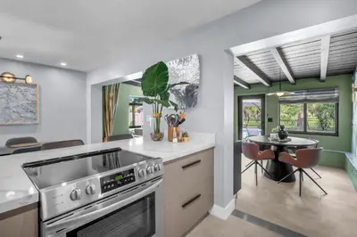 a kitchen with a stove and a table in it at Almost Famous - Pool - Jacuzzi in Fort Lauderdale