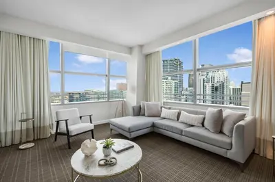 a living room with a couch and a large window at City View Condo in the Heart of Brickell in Miami