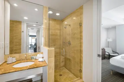 a bathroom with a glass shower and a sink at City View Condo in the Heart of Brickell in Miami