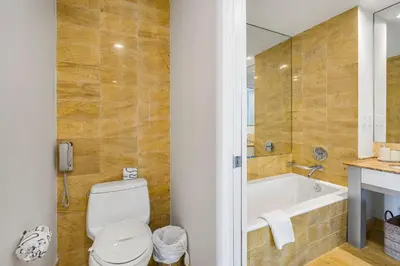 a bathroom with a tub and a toilet and a sink at City View Condo in the Heart of Brickell in Miami