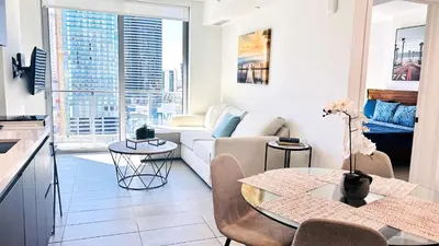 a living room with a couch and a table at Contemporary Comfort Rooftop Views & Full Kitchen in Miami