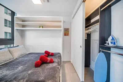 a red stuffed animal sitting on a bed in a room at Skyline Nomad Studio Walk to Kaseya Rooftop Pool in Miami