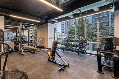 a gym with treadmills and exercise equipment in a building at Skyline Nomad Studio Walk to Kaseya Rooftop Pool in Miami