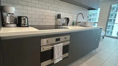 a kitchen with a sink and a stove top oven at Skyline Studio Workspace & Rooftop Pool in Miami