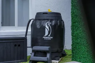 a trash can sitting in the grass next to a building at Steps to Sand! - Wellness Escape - Coastal Retreat in Fort Lauderdale