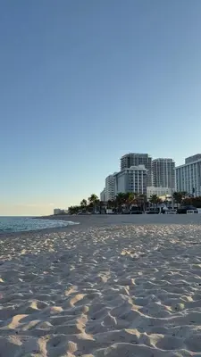 a sandy beach with buildings in the background at Steps to Sand! - Wellness Escape - Coastal Retreat in Fort Lauderdale