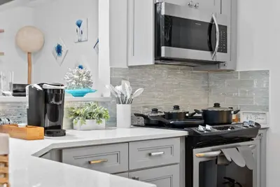 a kitchen with a stove and a microwave at Steps to Sand! - Wellness Escape - Coastal Retreat in Fort Lauderdale